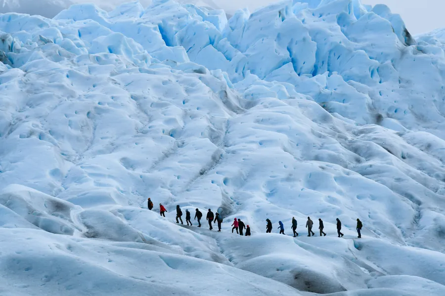 Fila de caminantes sobre el hielo del glaciar durante el minitrekking